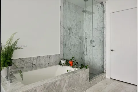 a bathroom with a bathtub and shower