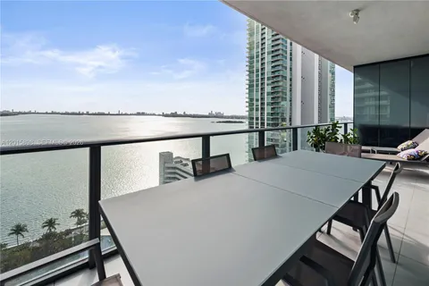 a balcony with table and chairs