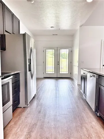 a view of a kitchen with a refrigerator a stove top oven