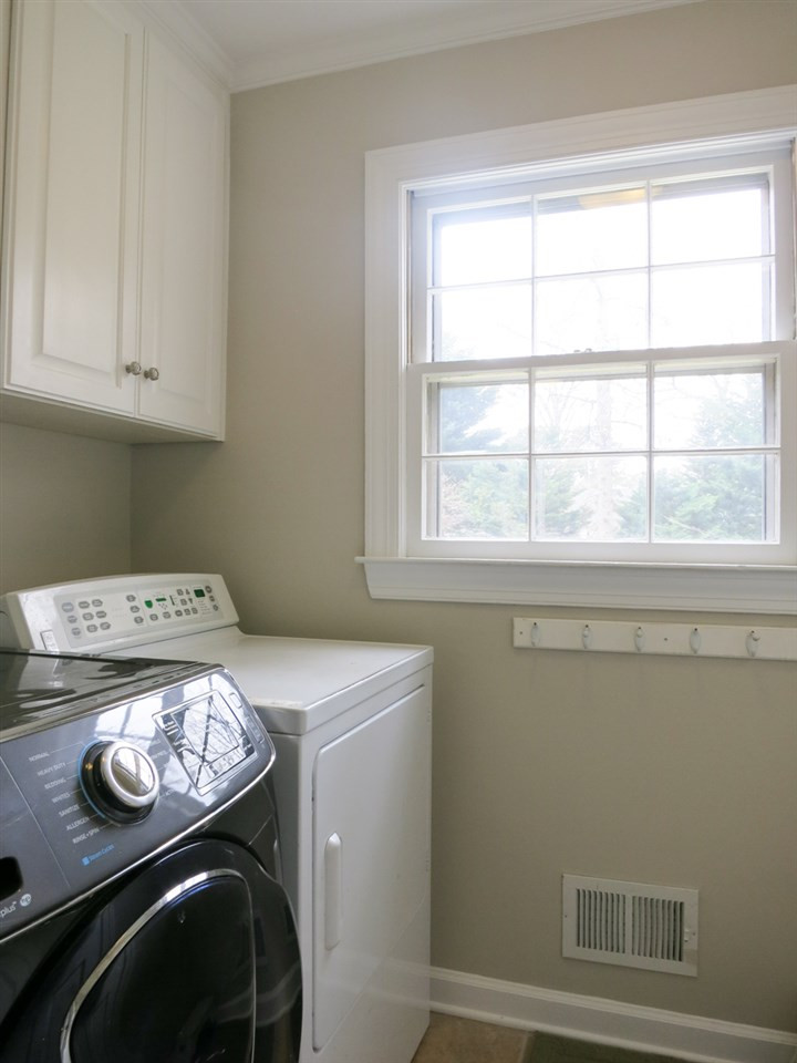 4713 Pemberton Drive Raleigh, NC 27609 - Photo 14 of 25 The nearby Laundry/Mud Rm w/wall cabinets & neutral vinyl flr leads to the Garage. Laundry/Mud Rm