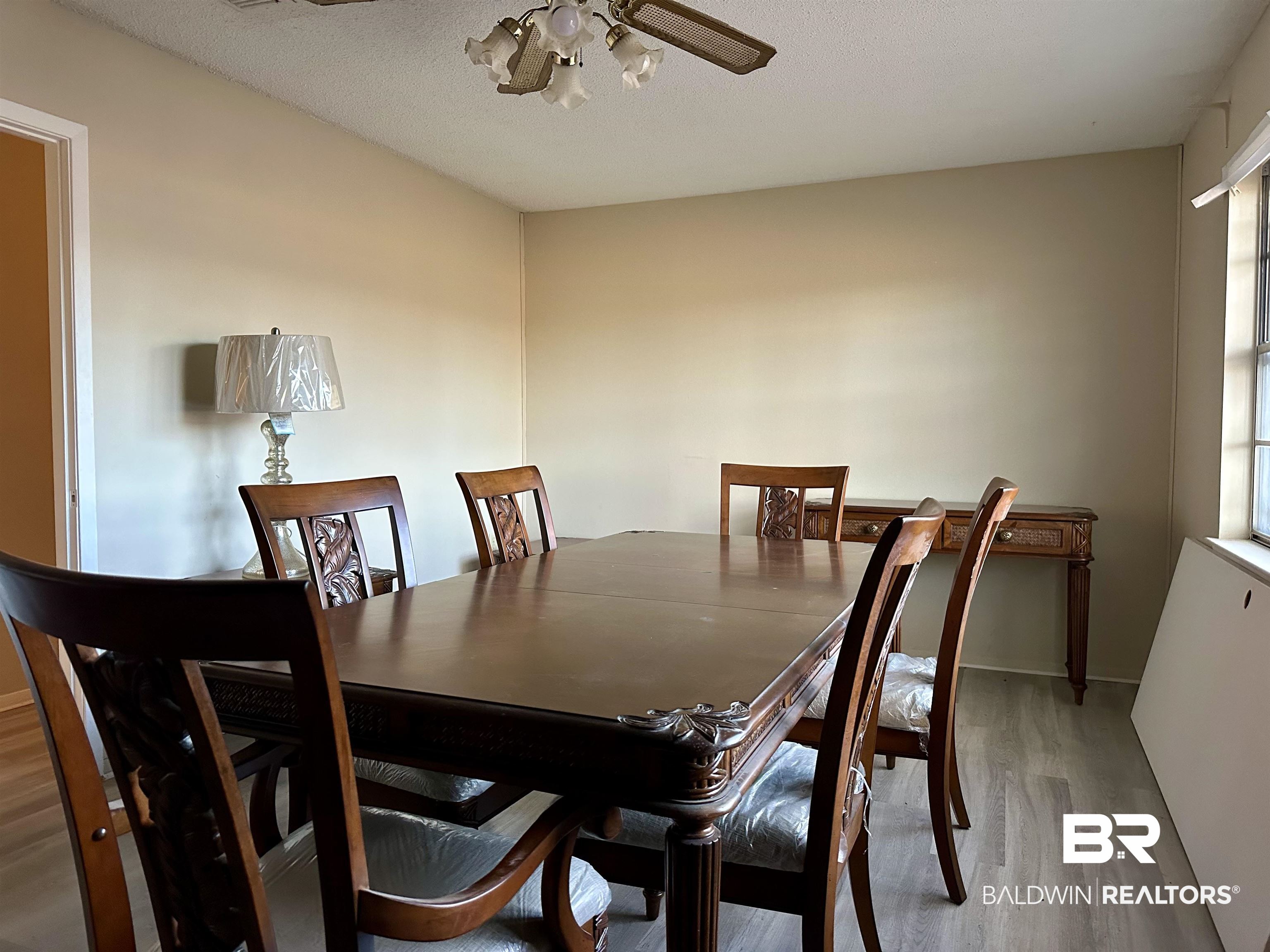 3451 Kirkland Road Brewton, AL 36426 - Photo 11 of 17 Dining space featuring a wealth of natural light, ceiling fan, hardwood / wood-style floors, and a textured ceiling