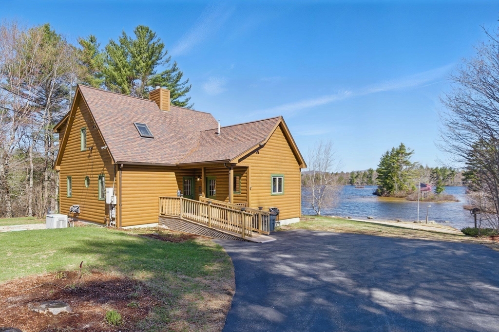 44 Auclair Road Middleton, NH 03887 - Photo 3 of 7 a view of a house with yard and a garden
