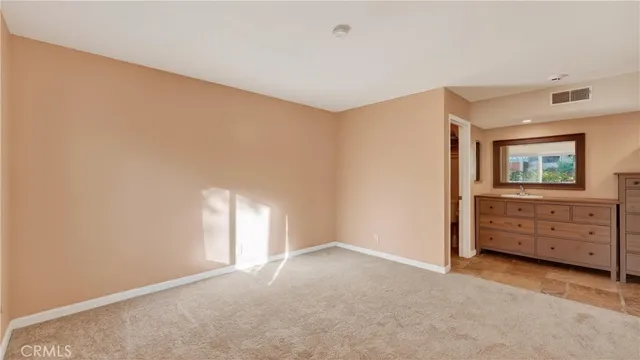 a bathroom with a granite countertop sink mirror next to a window