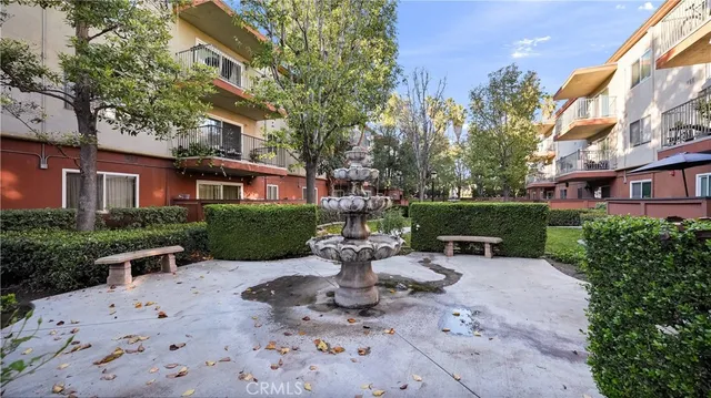 a view of a building with a yard and plants
