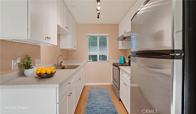 a kitchen with a sink and a refrigerator