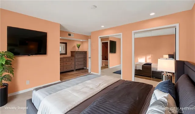 a bedroom with furniture and a flat screen tv