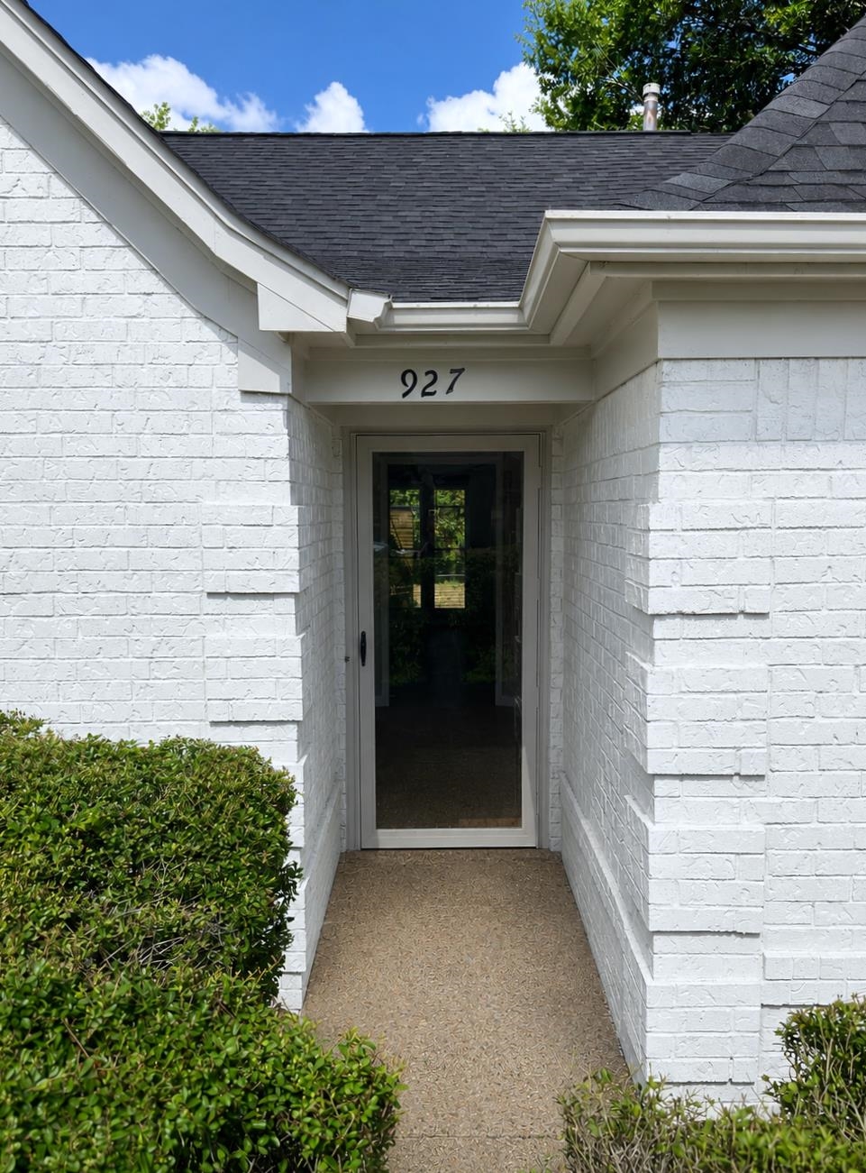 927 Cully Road Memphis, TN 38018 - Photo 29 of 33 White-painted brick exterior featuring a dark asphalt shingle roof