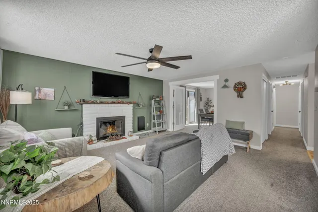 a living room with furniture a fireplace and a flat screen tv