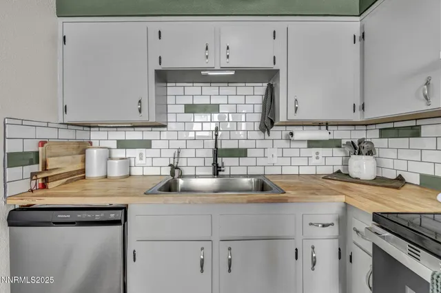 a kitchen with a sink cabinets and appliances