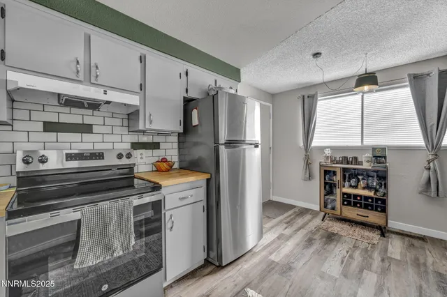 a kitchen with refrigerator a stove and a cabinets