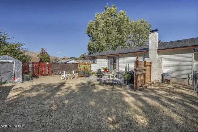 a view of a house with backyard porch and sitting area