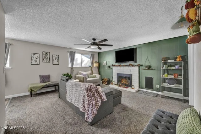 a living room with furniture a fireplace and a flat screen tv