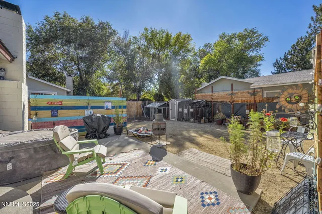 a view of a patio with table and chairs potted plants with wooden floor