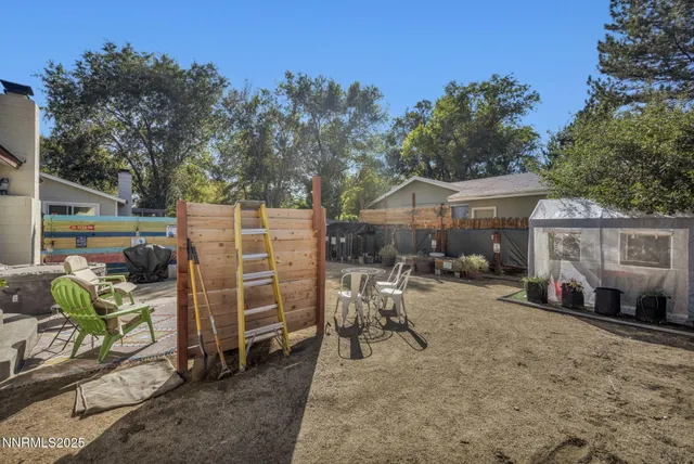 a view of a patio with a table and chairs under an umbrella