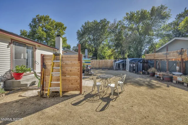 a view of a backyard with furniture