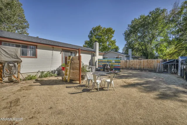 a view of a house with backyard and sitting area