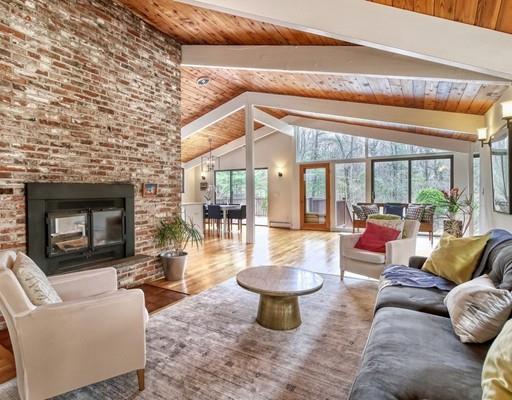 12 Meadowbrook Road Lincoln, MA 01773 - Photo 3 of 30 a living room with furniture a fireplace and a floor to ceiling window