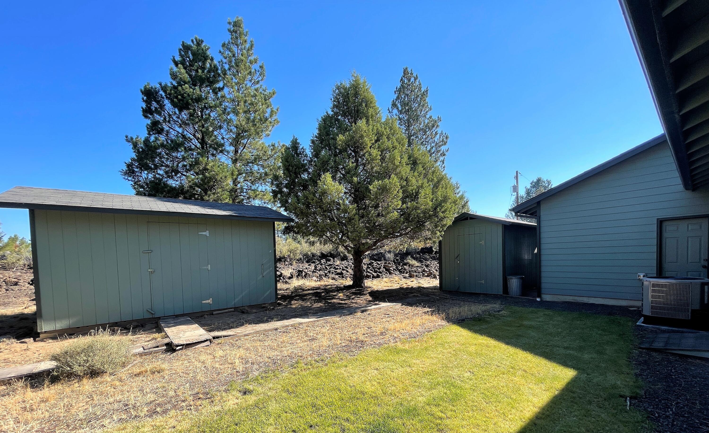 19761 Buck Canyon Road Bend, OR 97702 - Photo 23 of 33 North side of house - 2 storage sheds