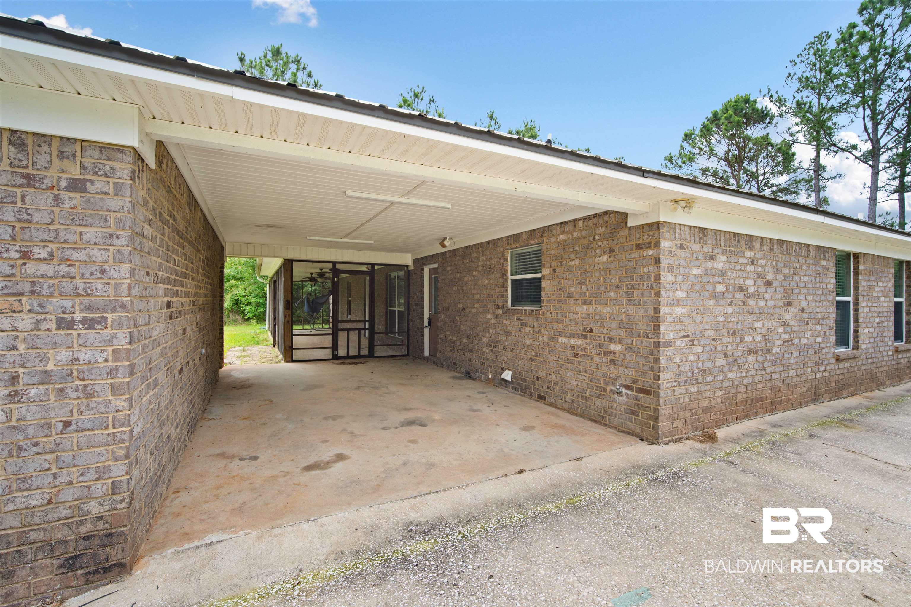 3010 Drag Strip Lane Coden, AL 36523 - Photo 33 of 44 View of side of property featuring brick siding and a carport
