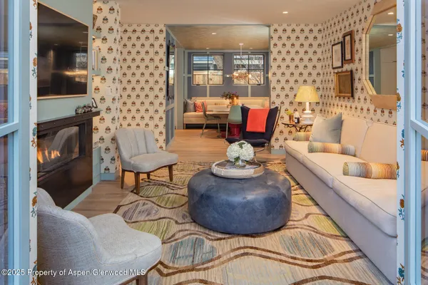 a living room with furniture and a fireplace