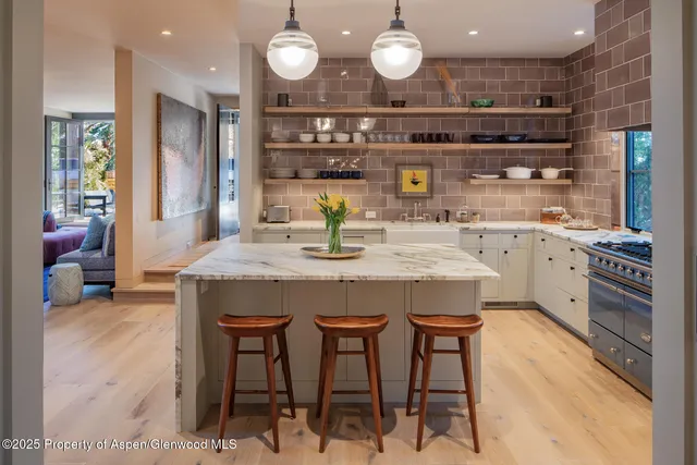 a kitchen with stainless steel appliances granite countertop a stove a sink and a refrigerator