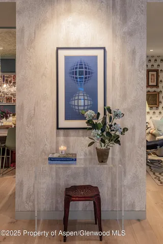 a glass table with chairs and a potted plant