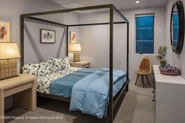 a bedroom with a bed couch and a window