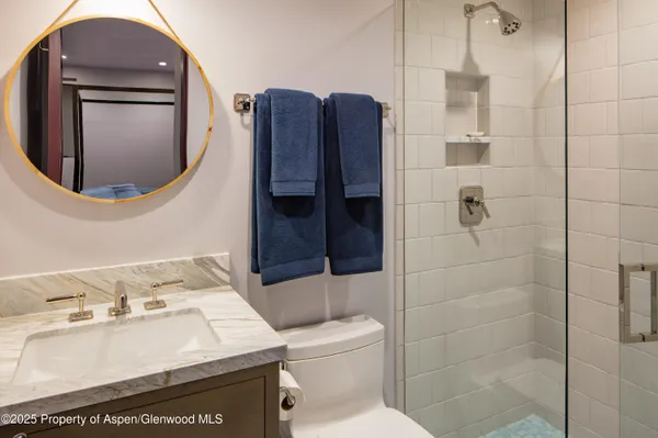 a bathroom with a sink toilet and shower