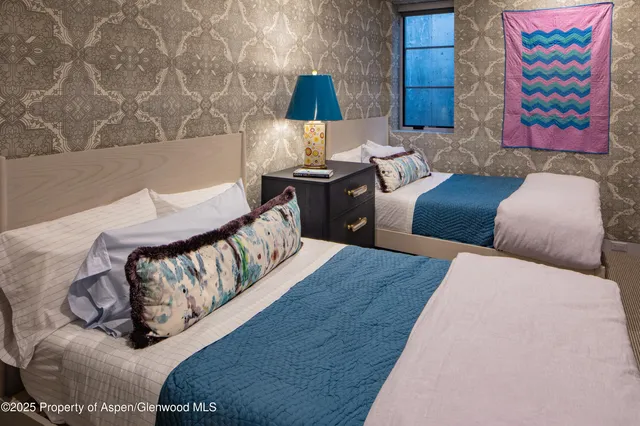 a bedroom with a bed and a lamp with the wooden floor