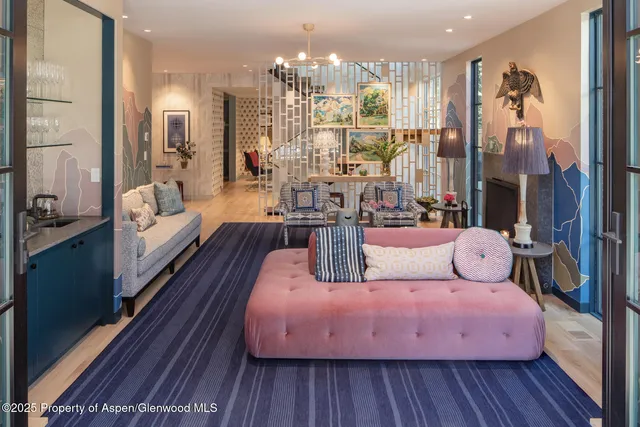 a living room with furniture and a chandelier