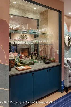 a room with stainless steel appliances wooden floor