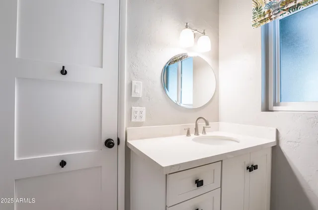 a bathroom with a sink and a mirror