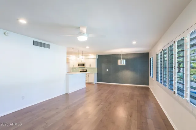 a view of a kitchen with a sink and wooden floor