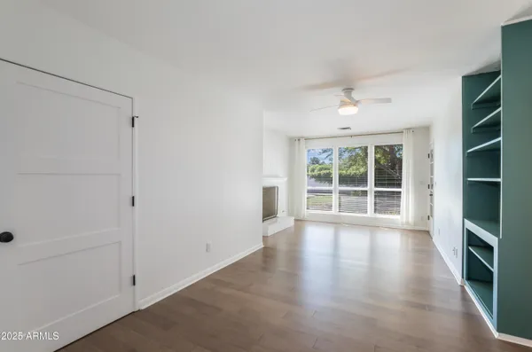 wooden floor in an empty room with a window