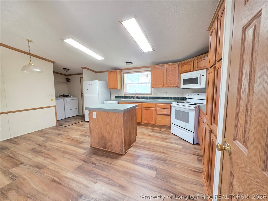 124 Franklin Road Raeford, NC 28376 - Photo 8 of 15 a kitchen with stainless steel appliances granite countertop a refrigerator a sink dishwasher a stove with wooden cabinets and floor