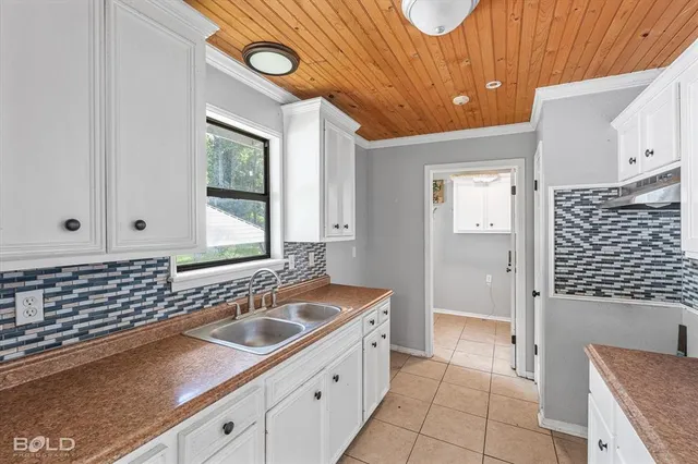 a bathroom with a sink mirror and a bathtub
