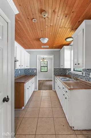 a large kitchen with granite countertop a stove a sink and dishwasher with a granite countertops