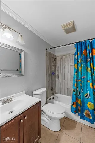 a bathroom with a sink a toilet and shower curtain