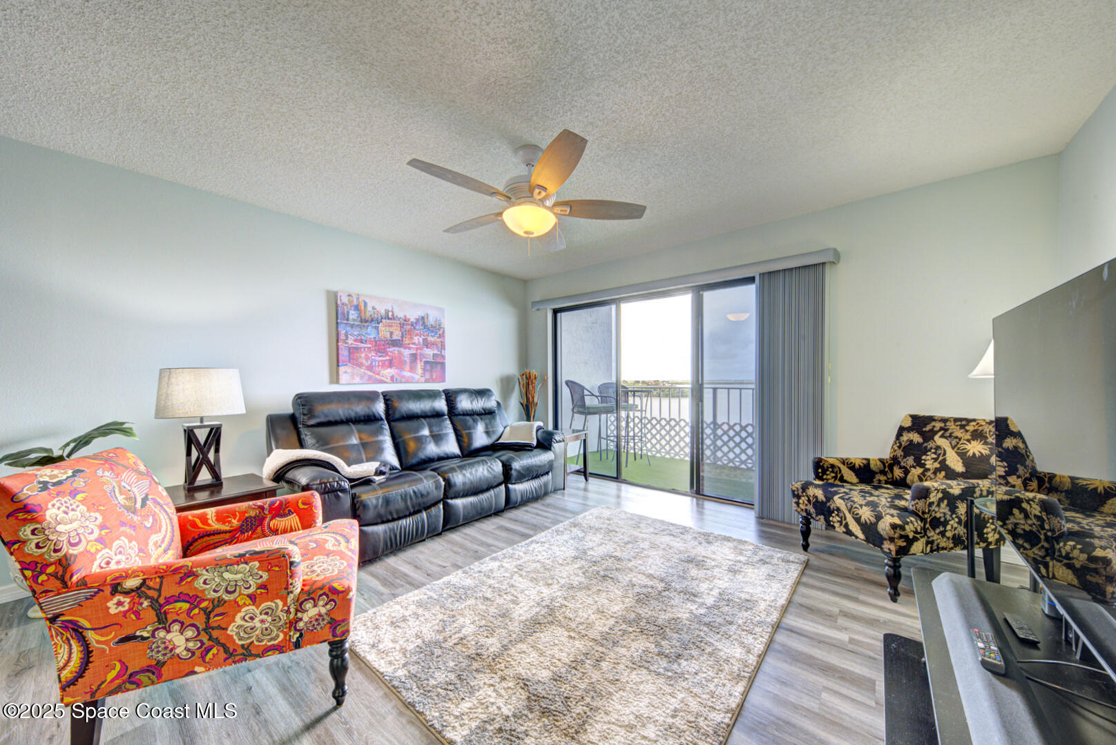 190 Seminole Lane, Unit 503 Cocoa Beach, FL 32931 - Photo 8 of 31 living room with slider to balcony