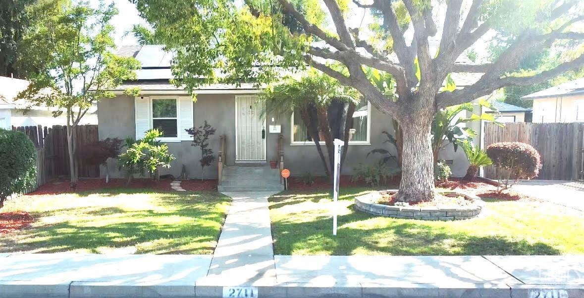 a view of a house with a yard in the background