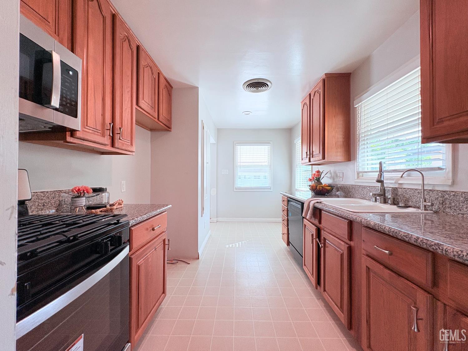 Undisclosed Address Bakersfield, CA 93301 - Photo 4 of 11 a kitchen with stainless steel appliances granite countertop a stove and a sink