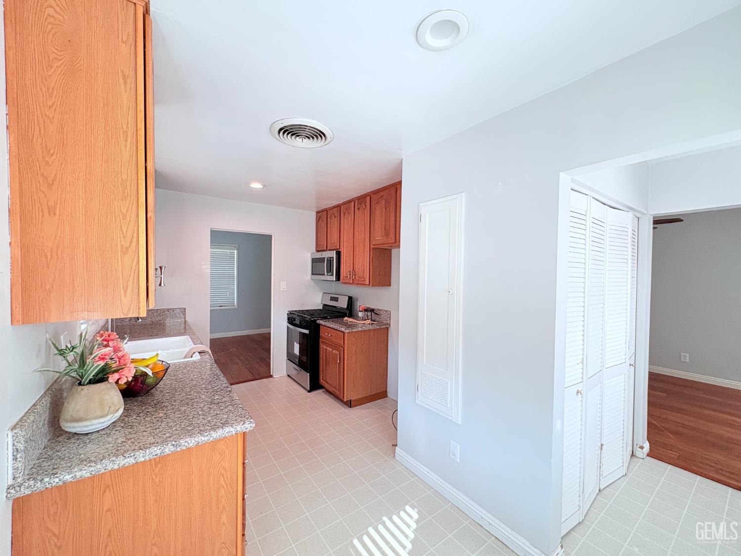 Undisclosed Address Bakersfield, CA 93301 - Photo 5 of 11 a kitchen with stainless steel appliances granite countertop a sink refrigerator and cabinets