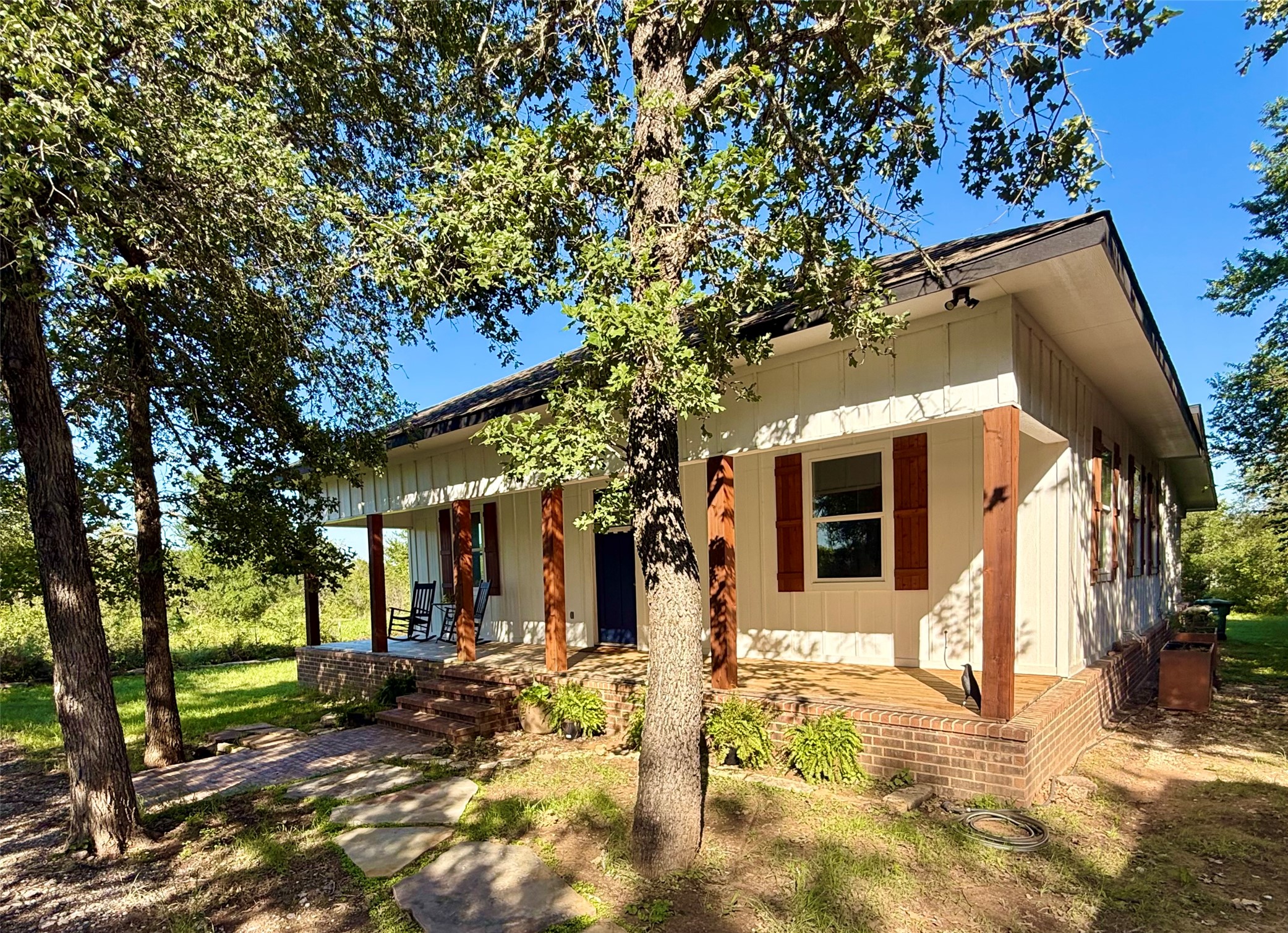 White vertical siding exterior with contrasting red shutters