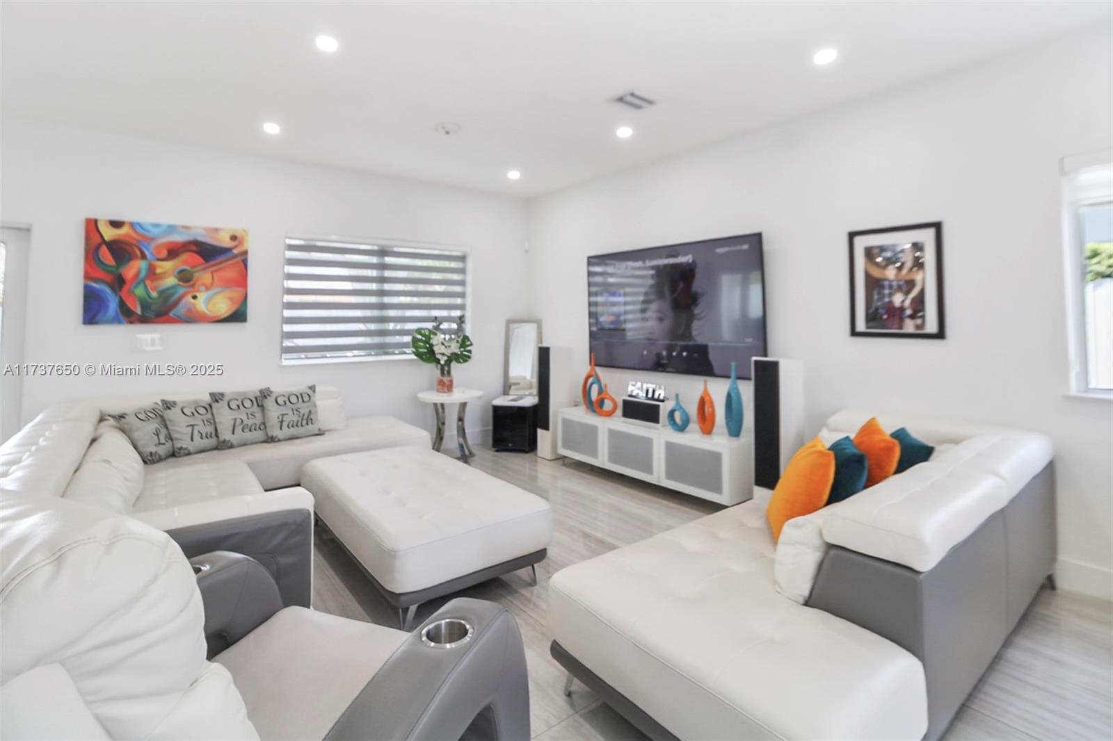 10290 Southwest 7th Terrace Sweetwater, FL 33174 - Photo 12 of 58 a living room with furniture and a flat screen tv