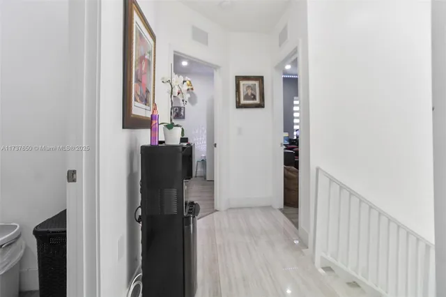 a en suite bathroom with a granite countertop sink a mirror and a potted plant