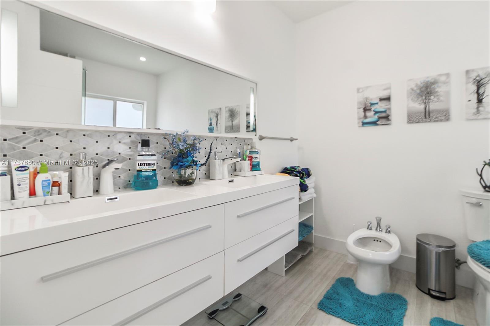 10290 Southwest 7th Terrace Sweetwater, FL 33174 - Photo 29 of 58 a bathroom with a toilet sink and mirror