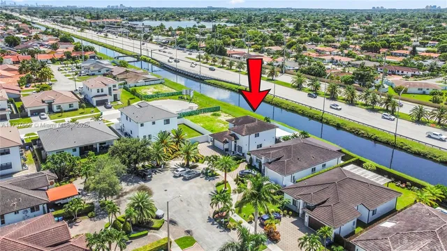 a view of a patio with table and chairs with wooden floor and fence