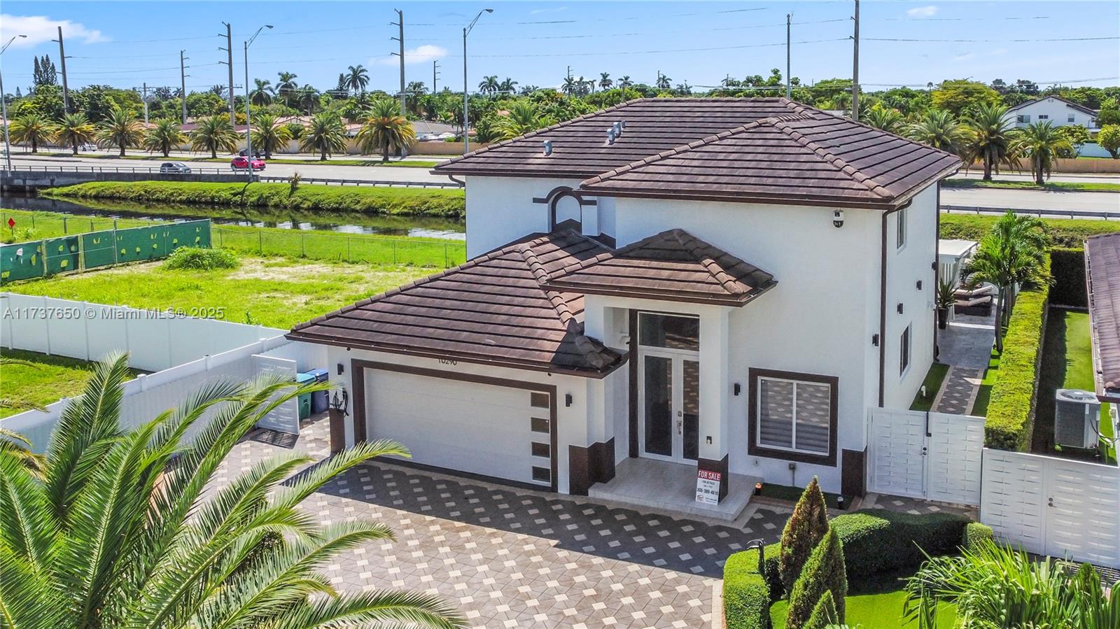 10290 Southwest 7th Terrace Sweetwater, FL 33174 - Photo 6 of 58 a view of a patio with table and chairs with wooden floor and fence