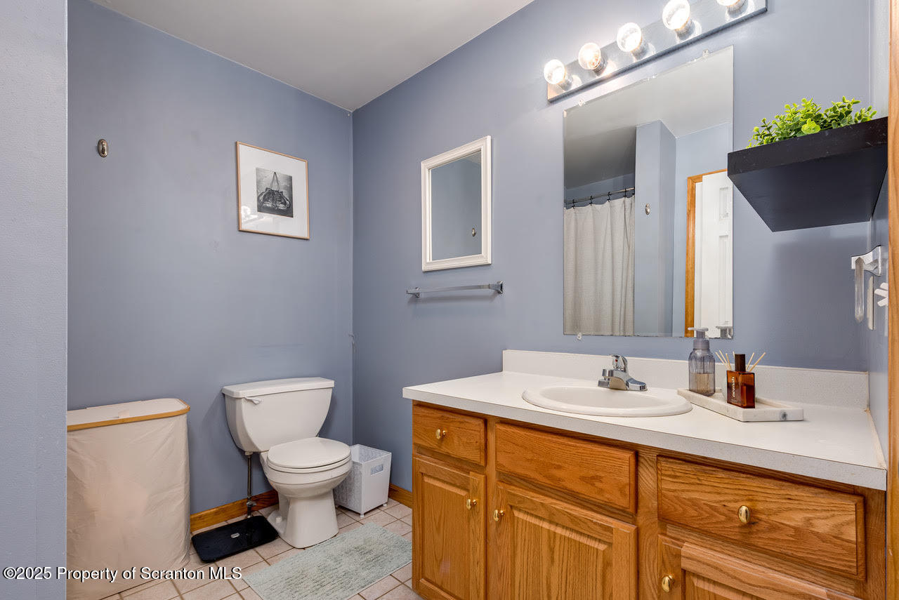 4 Scott Street Moosic, PA 18507 - Photo 19 of 23 a bathroom with a toilet sink and mirror