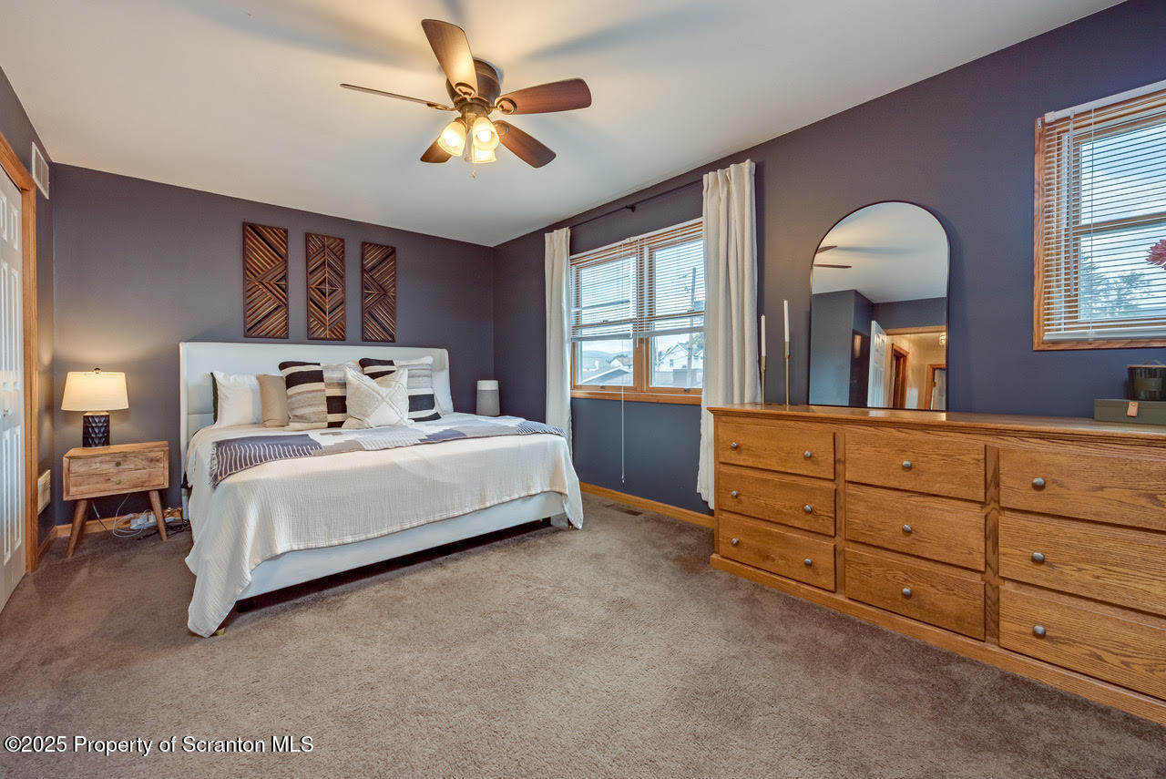 4 Scott Street Moosic, PA 18507 - Photo 20 of 23 a bedroom with a large bed and a chandelier